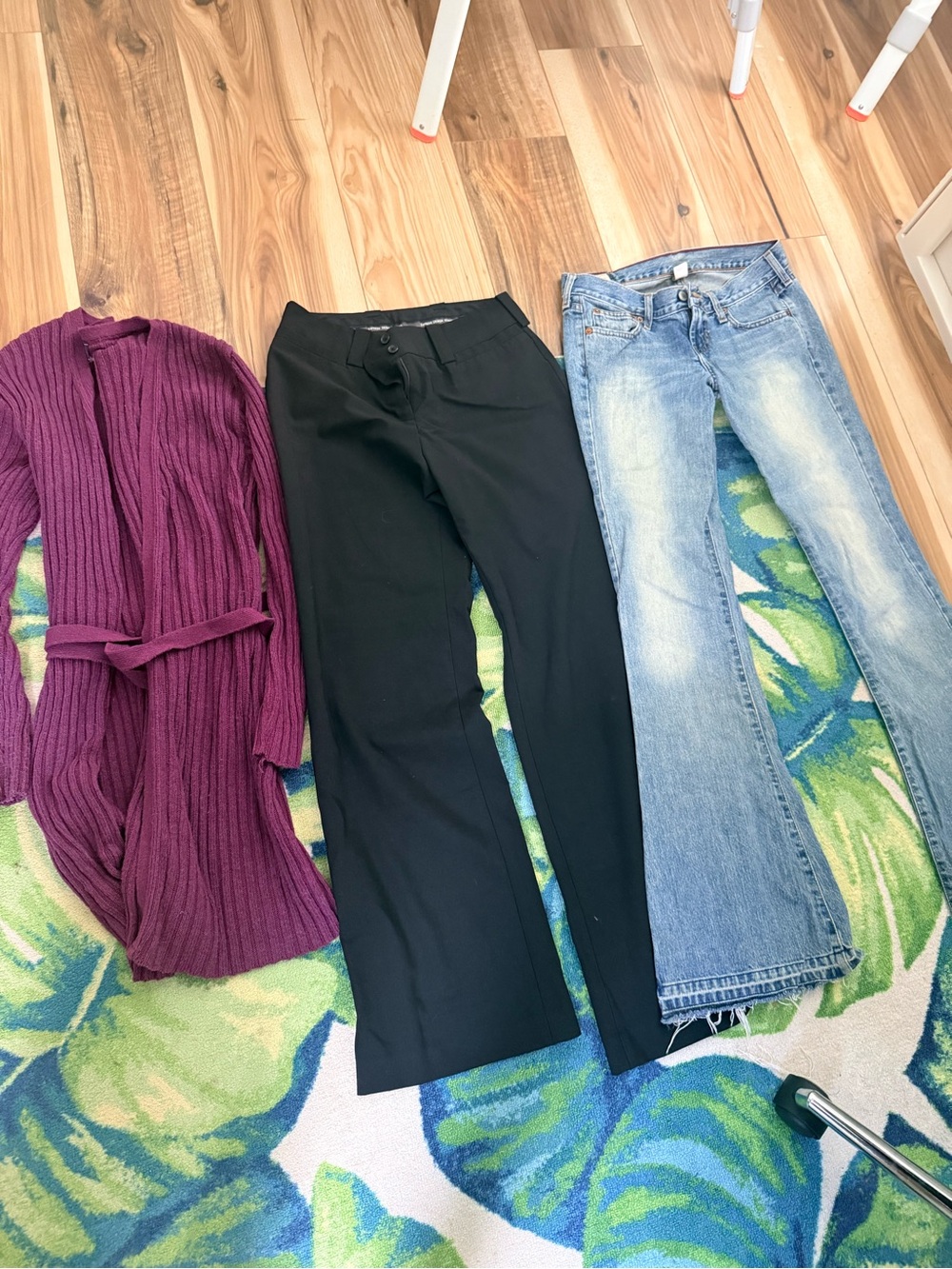Purple cardigan and black dress pants and jeans